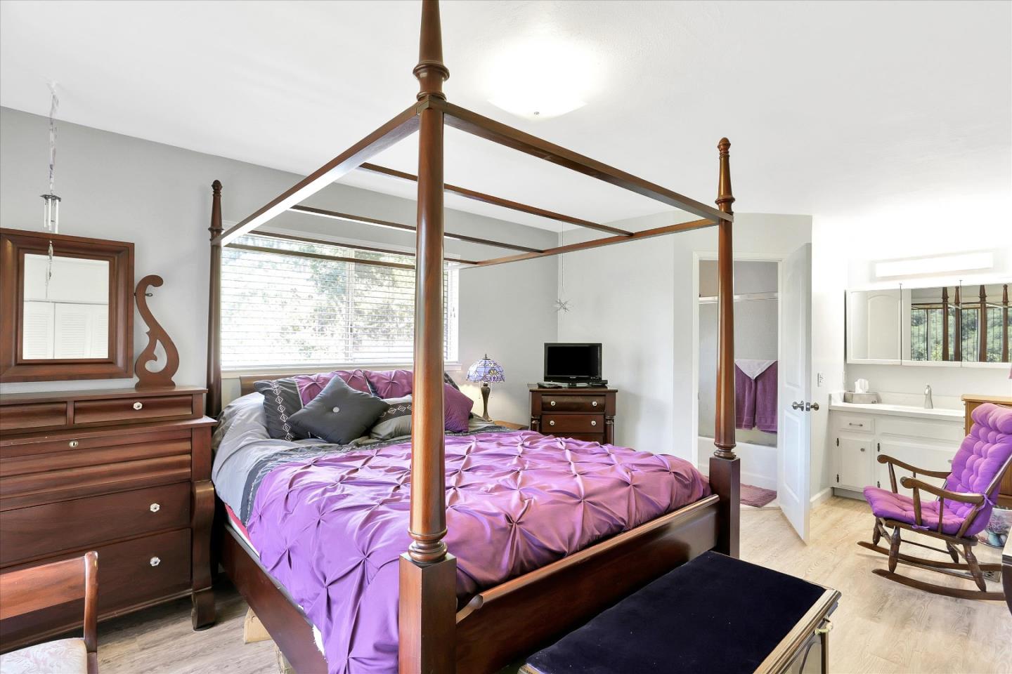 630 Paradise Road Salinas, CA 93907 - Photo 17 of 37 a bedroom with a bed a chandelier and a flat tv screen