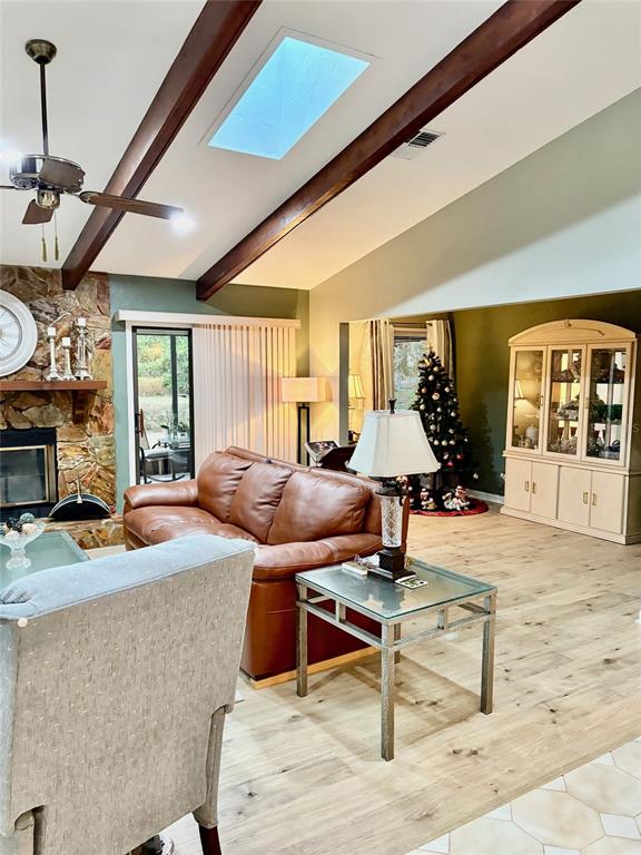 19807 Southwest 85th Loop Dunnellon, FL 34432 - Photo 13 of 60 a living room with furniture a fireplace and a large window