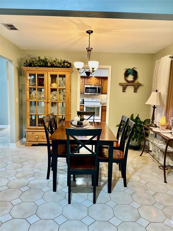 19807 Southwest 85th Loop Dunnellon, FL 34432 - Photo 15 of 60 a view of a dining room with furniture and a window