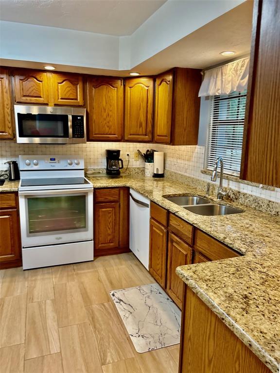19807 Southwest 85th Loop Dunnellon, FL 34432 - Photo 22 of 60 a kitchen with stainless steel appliances granite countertop a stove a sink and a microwave