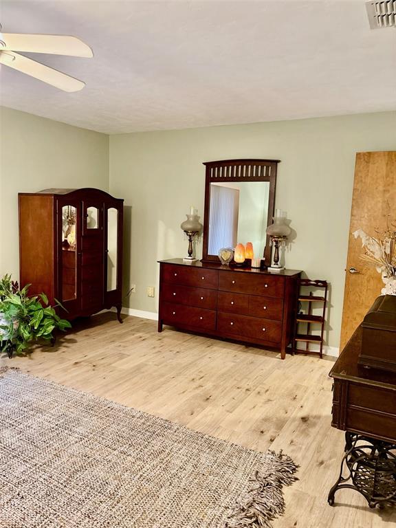 19807 Southwest 85th Loop Dunnellon, FL 34432 - Photo 29 of 60 a spacious bedroom with a bed and a table in it