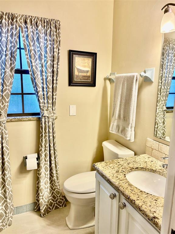 19807 Southwest 85th Loop Dunnellon, FL 34432 - Photo 36 of 60 a bathroom with a granite countertop sink toilet and shower