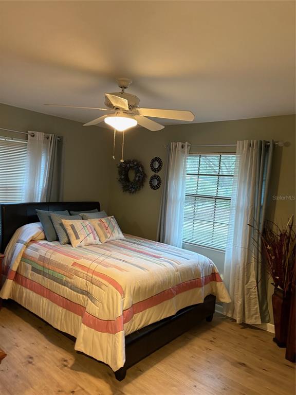 19807 Southwest 85th Loop Dunnellon, FL 34432 - Photo 42 of 60 a bedroom with a bed and a flat tv screen on dresser