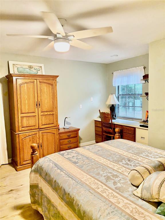 19807 Southwest 85th Loop Dunnellon, FL 34432 - Photo 47 of 60 a bedroom with a bed and wooden floor