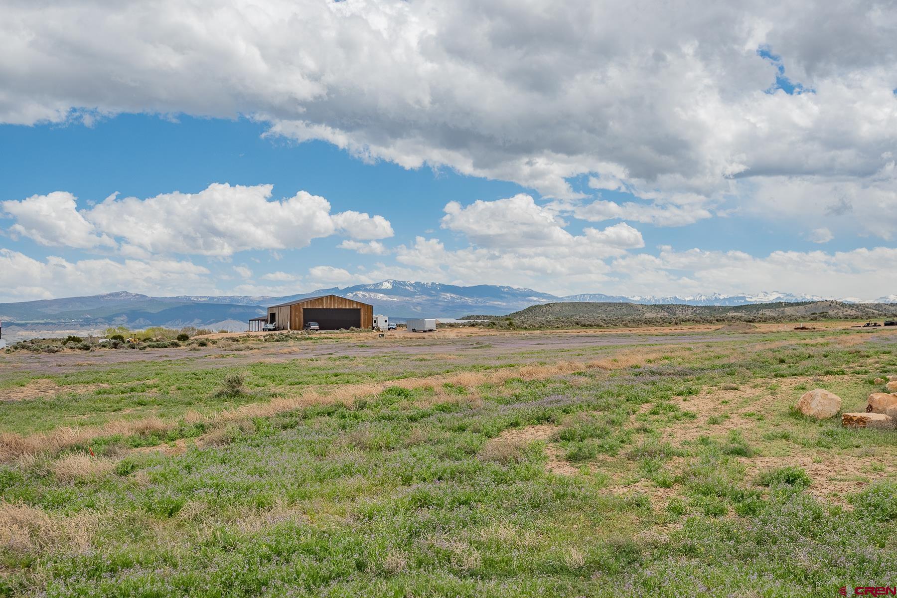 Lot 3 6300th Road Montrose, CO 81403 - Photo 13 of 25 a view of a lake and mountain with trees in the background