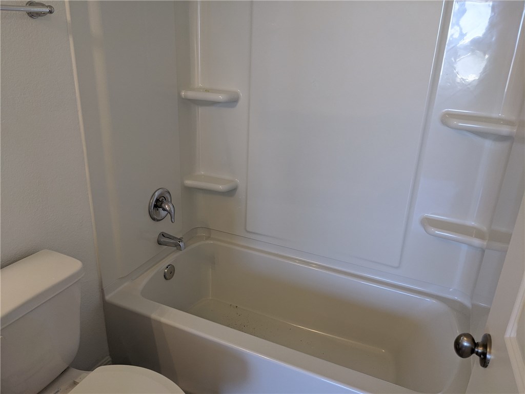 6705 Routenburn Street Austin, TX 78754 - Photo 16 of 18 a bathroom with a bathtub and toilet