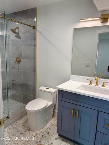 a view of an empty room with a window and fireplace