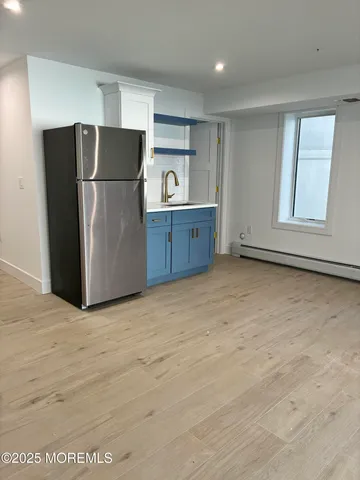 a kitchen with kitchen island a sink a stove and white cabinets