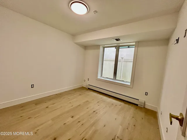 a view of a brick house with a small yard