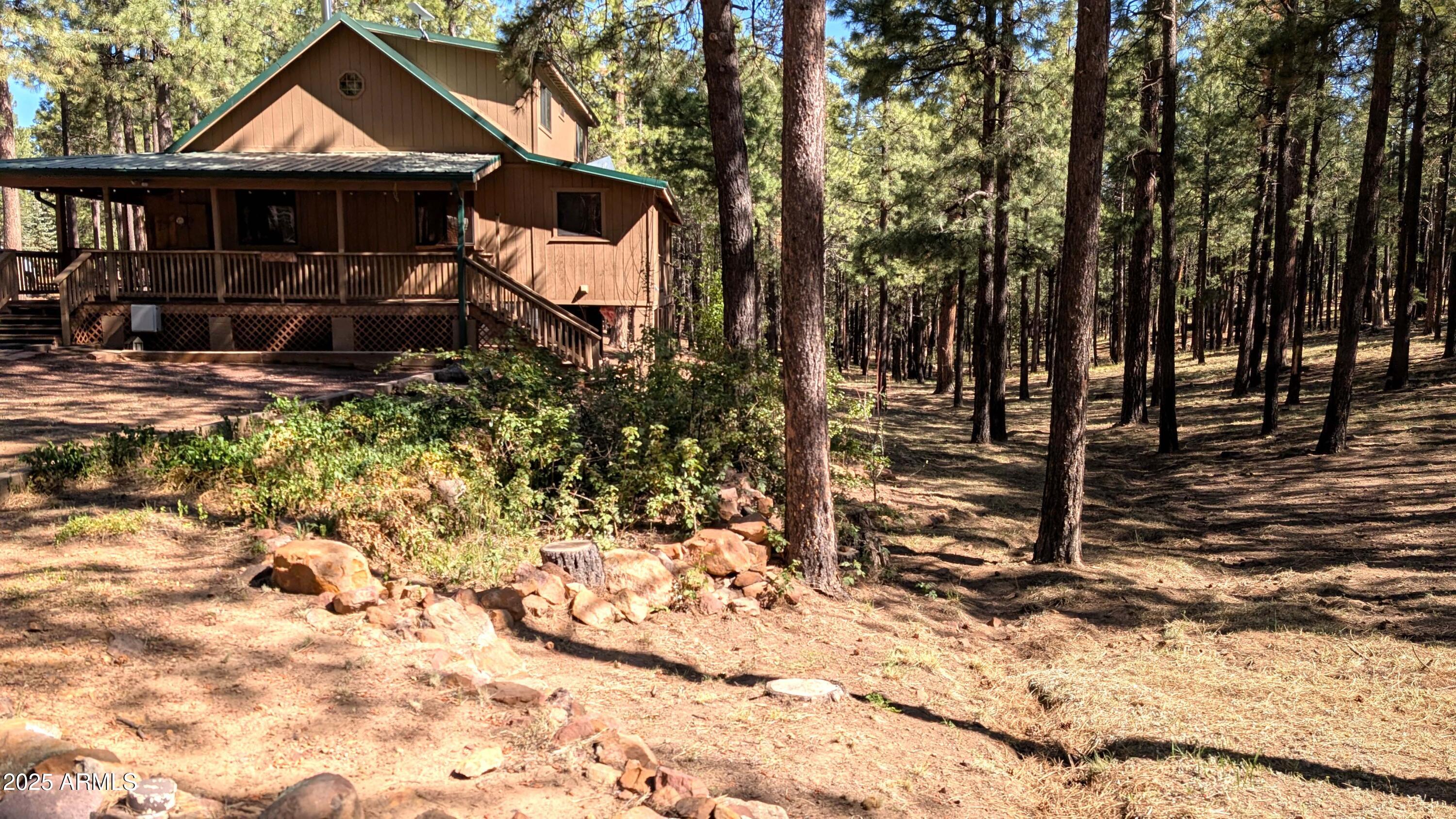 2425 Tall Trees Loop Forest Lakes, AZ 85931 - Photo 8 of 43 a front view of a house with a yard