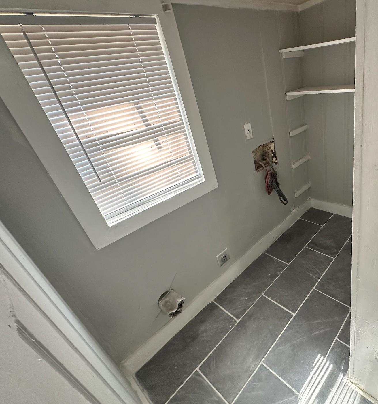 3579 Kendrick Road Memphis, TN 38108 - Photo 4 of 8 Washroom featuring hookup for an electric dryer and dark tile patterned floors
