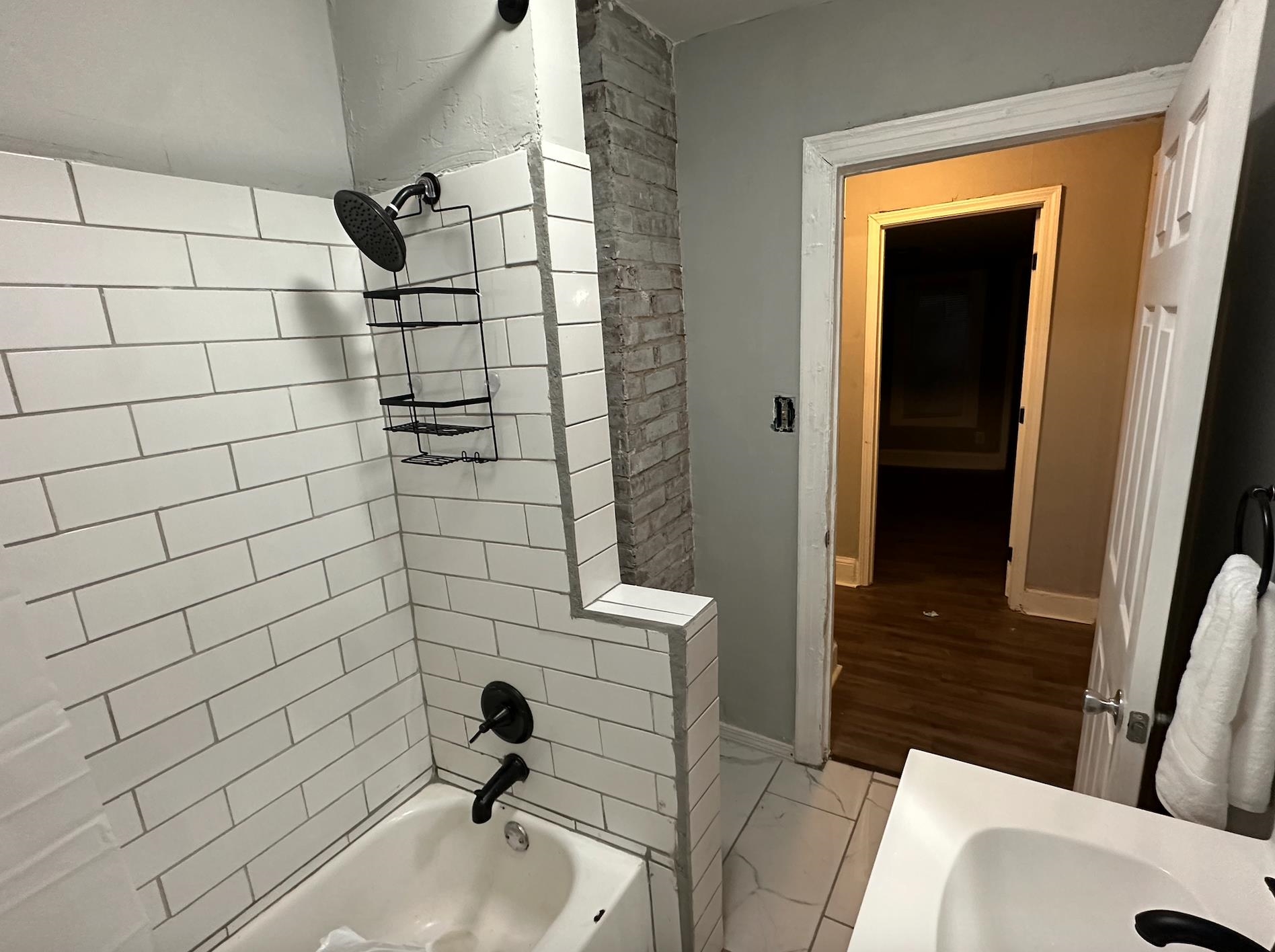 3579 Kendrick Road Memphis, TN 38108 - Photo 8 of 8 Bathroom with hardwood / wood-style floors and tiled shower / bath combo