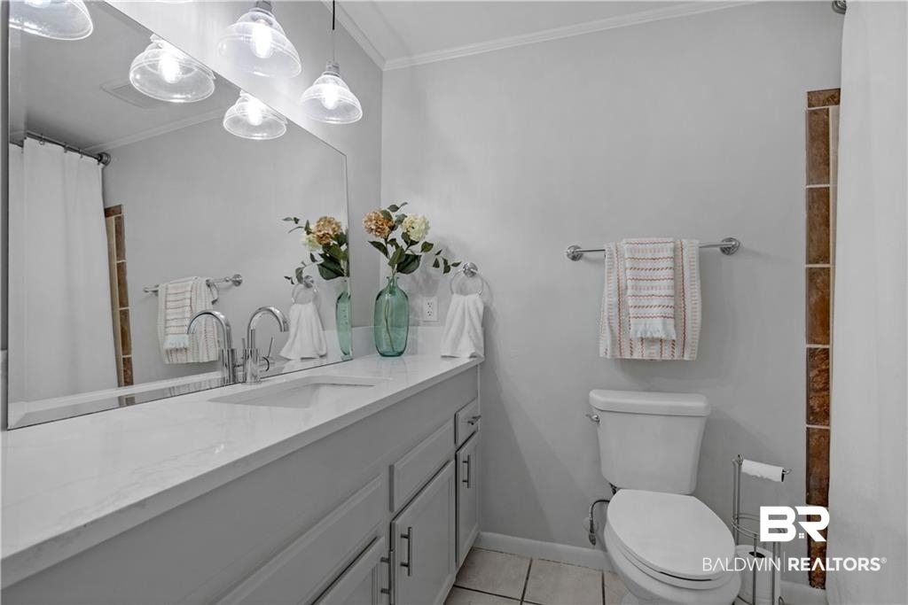 1624 Apex Drive Mobile, AL 36693 - Photo 21 of 29 Bathroom with toilet, crown molding, vanity, and tile patterned floors