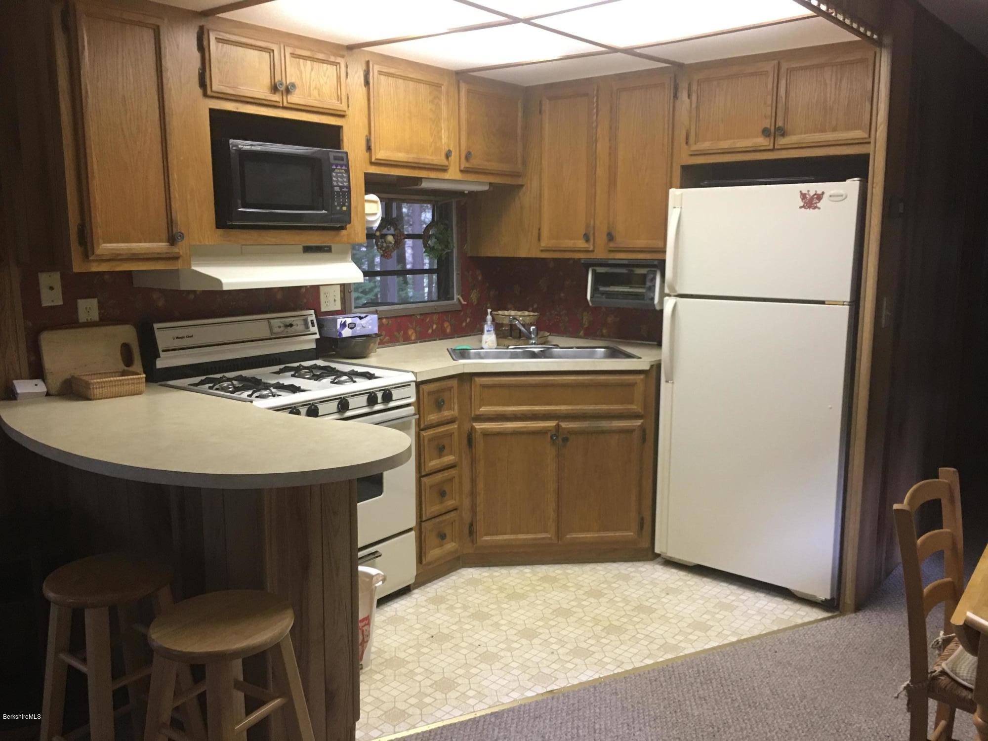 7 North Main Road Otis, MA 01253 - Photo 11 of 24 a kitchen with a sink a stove and refrigerator