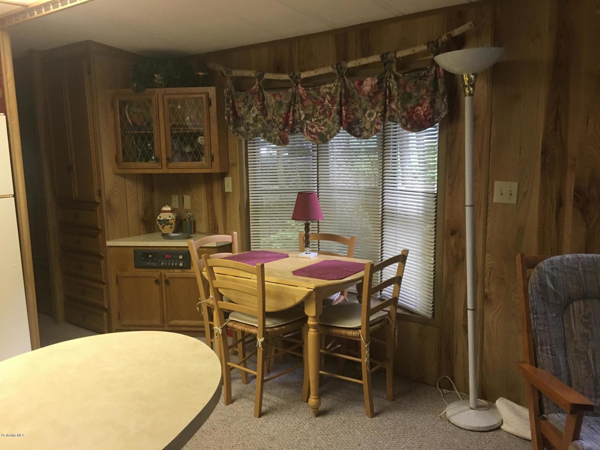 7 North Main Road Otis, MA 01253 - Photo 12 of 24 a dining room with a table and chairs