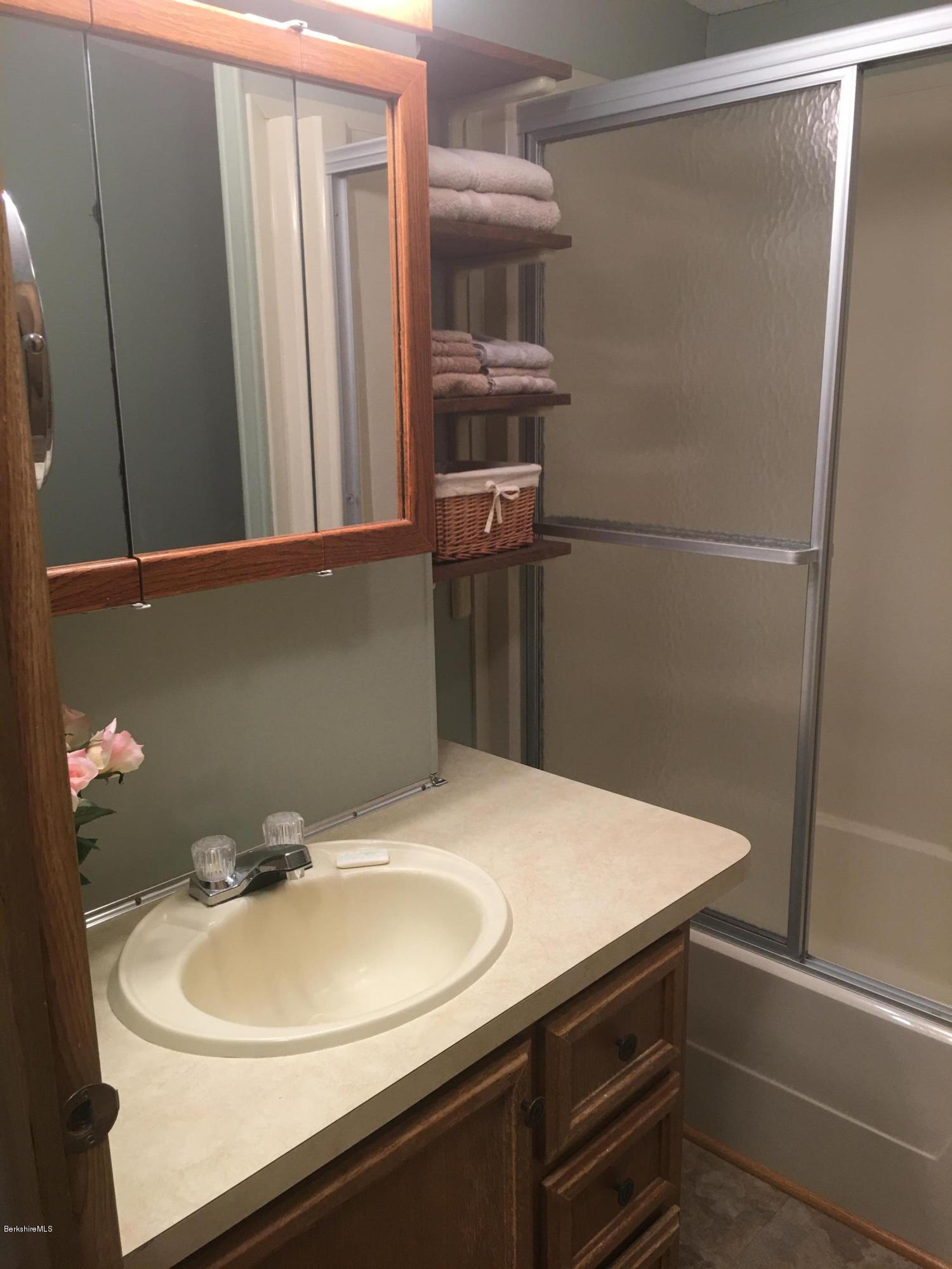 7 North Main Road Otis, MA 01253 - Photo 13 of 24 a bathroom with a sink and mirror