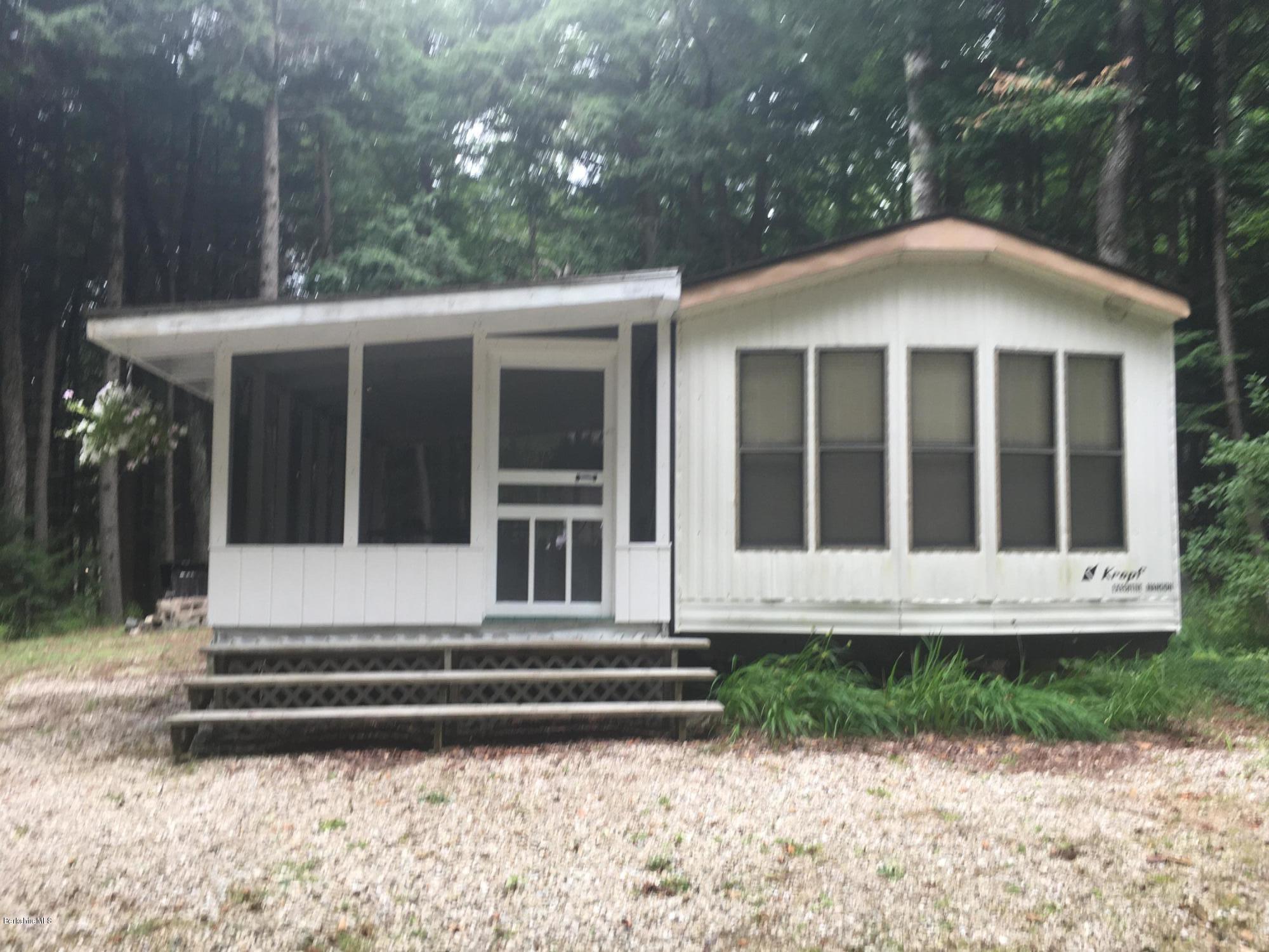 7 North Main Road Otis, MA 01253 - Photo 18 of 24 a front view of a house with a yard and potted plants