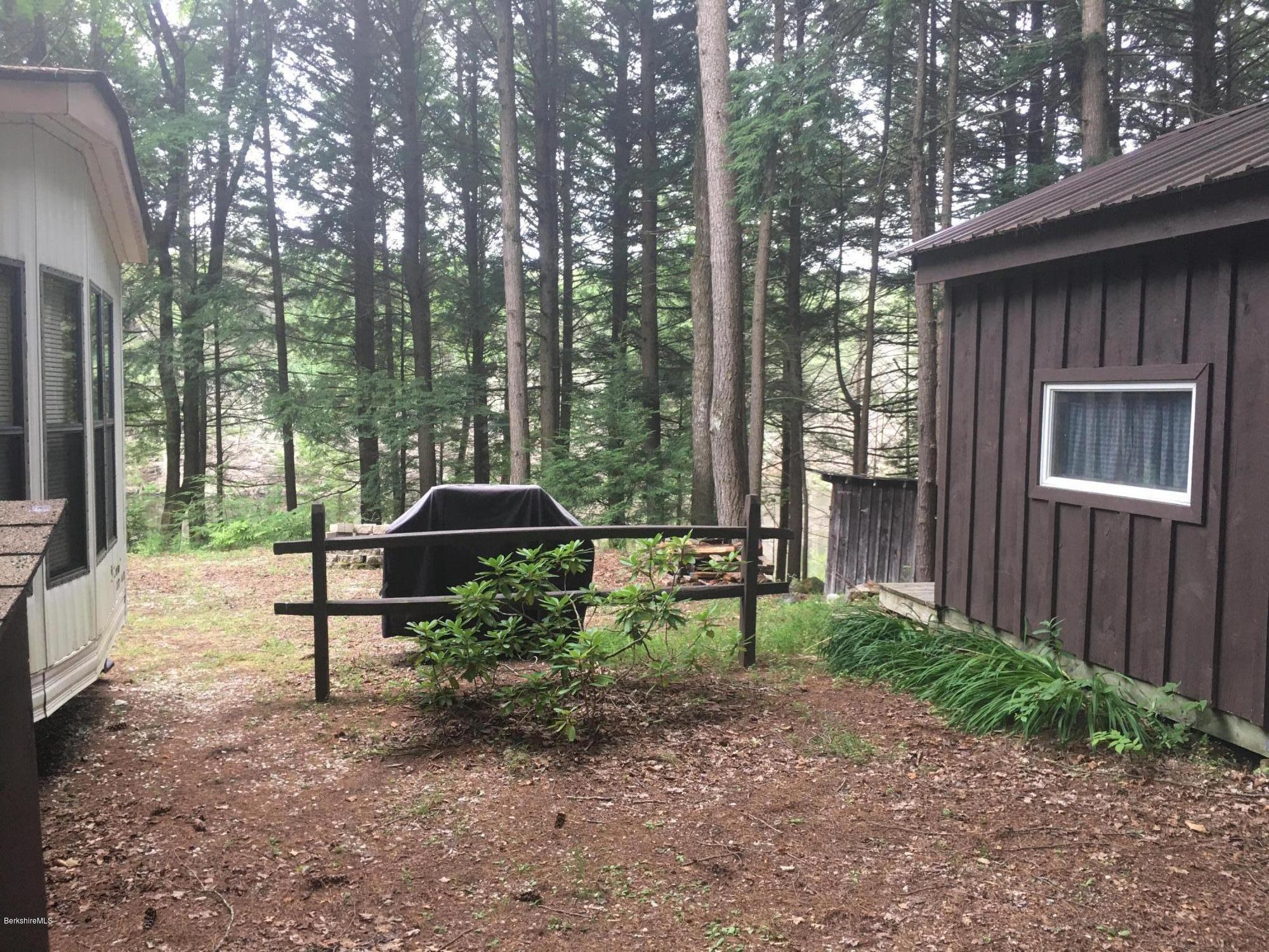 7 North Main Road Otis, MA 01253 - Photo 20 of 24 a backyard of a house with table and chairs