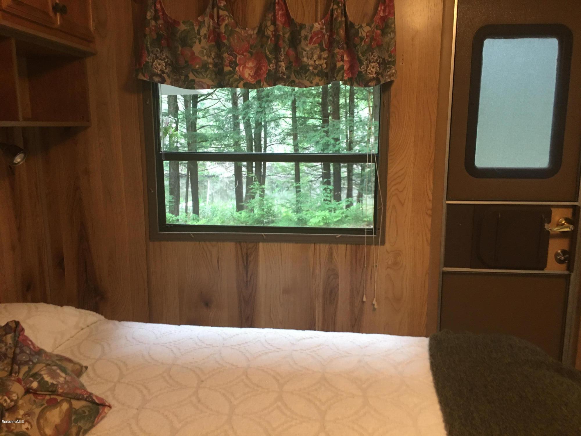 7 North Main Road Otis, MA 01253 - Photo 4 of 24 a bedroom with a bed and a window