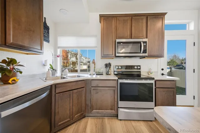 a kitchen with stainless steel appliances granite countertop a sink and stove top oven