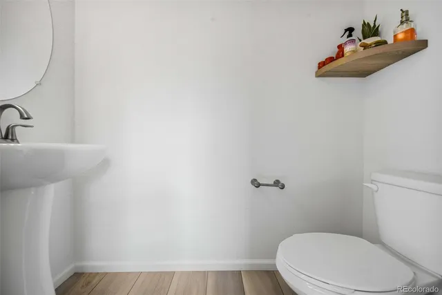 a white toilet sitting next to a bathroom sink
