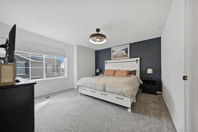 a bedroom with a bed and window