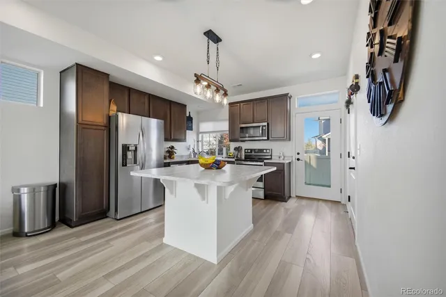 a kitchen with stainless steel appliances a refrigerator sink and cabinets