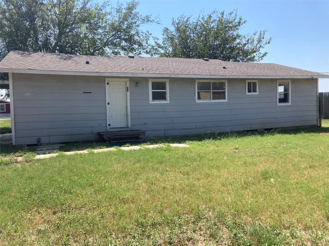 a backyard of a house with yard and outdoor seating