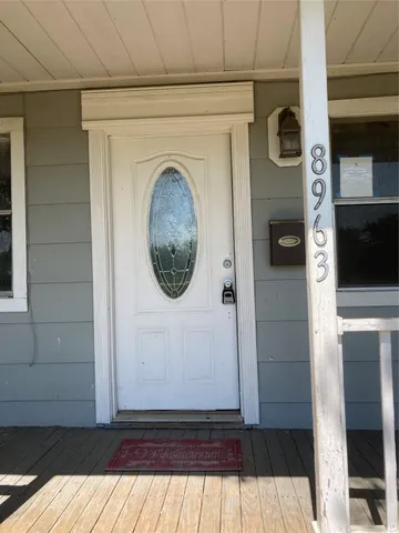 a view of a door and wooden floor