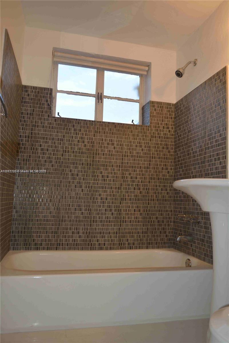 635 83rd Street, Unit 47 Miami Beach, FL 33141 - Photo 11 of 16 a bathroom with a bathtub and a shower