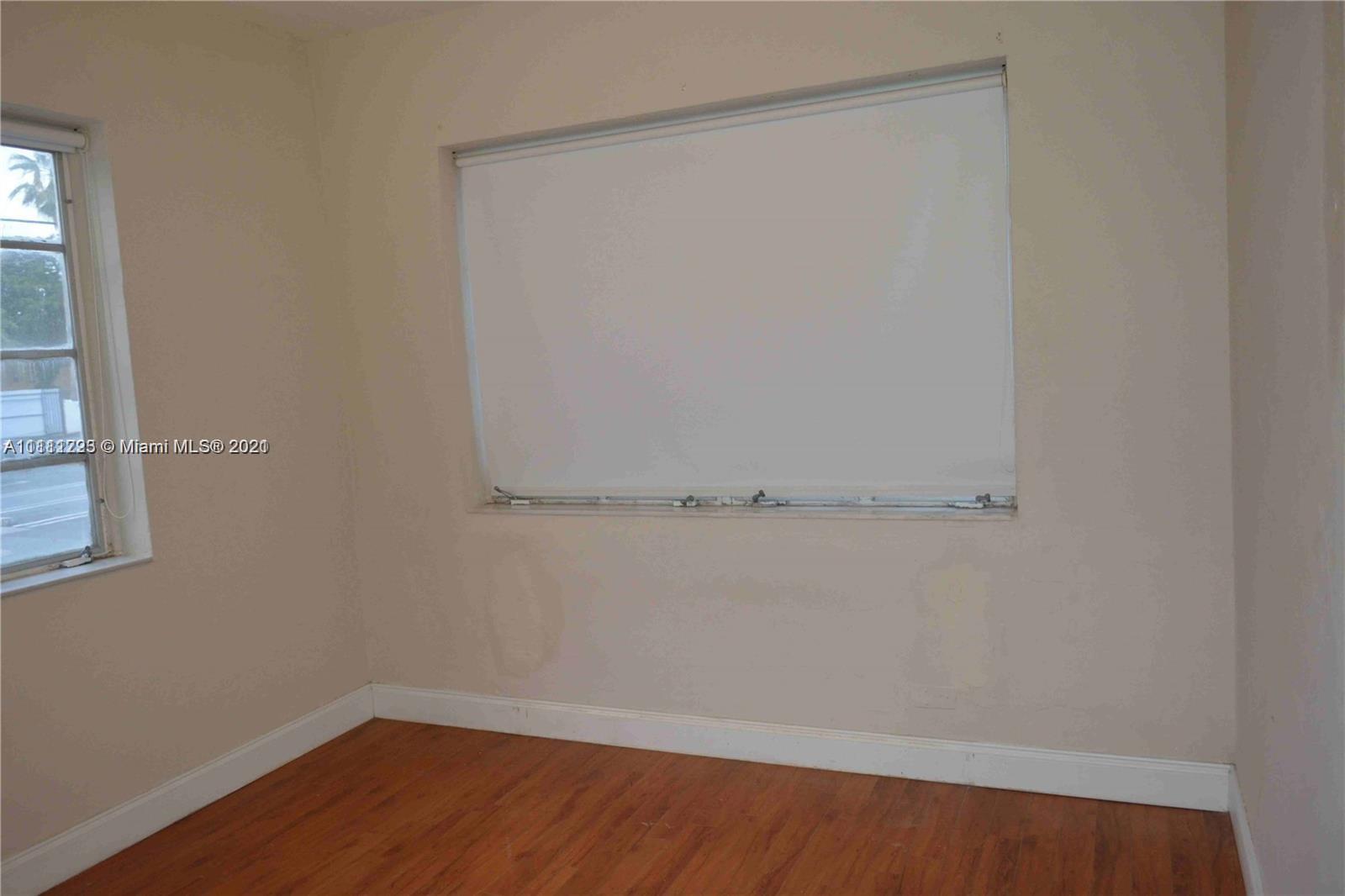 635 83rd Street, Unit 47 Miami Beach, FL 33141 - Photo 12 of 16 a view of a small space with wooden floor and small window