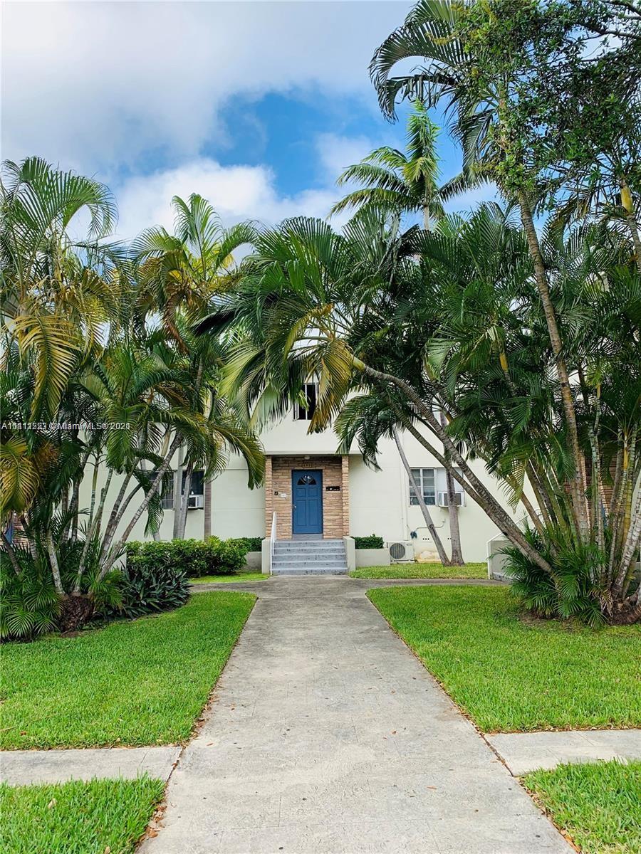 635 83rd Street, Unit 47 Miami Beach, FL 33141 - Photo 2 of 16 a front view of a house with garden