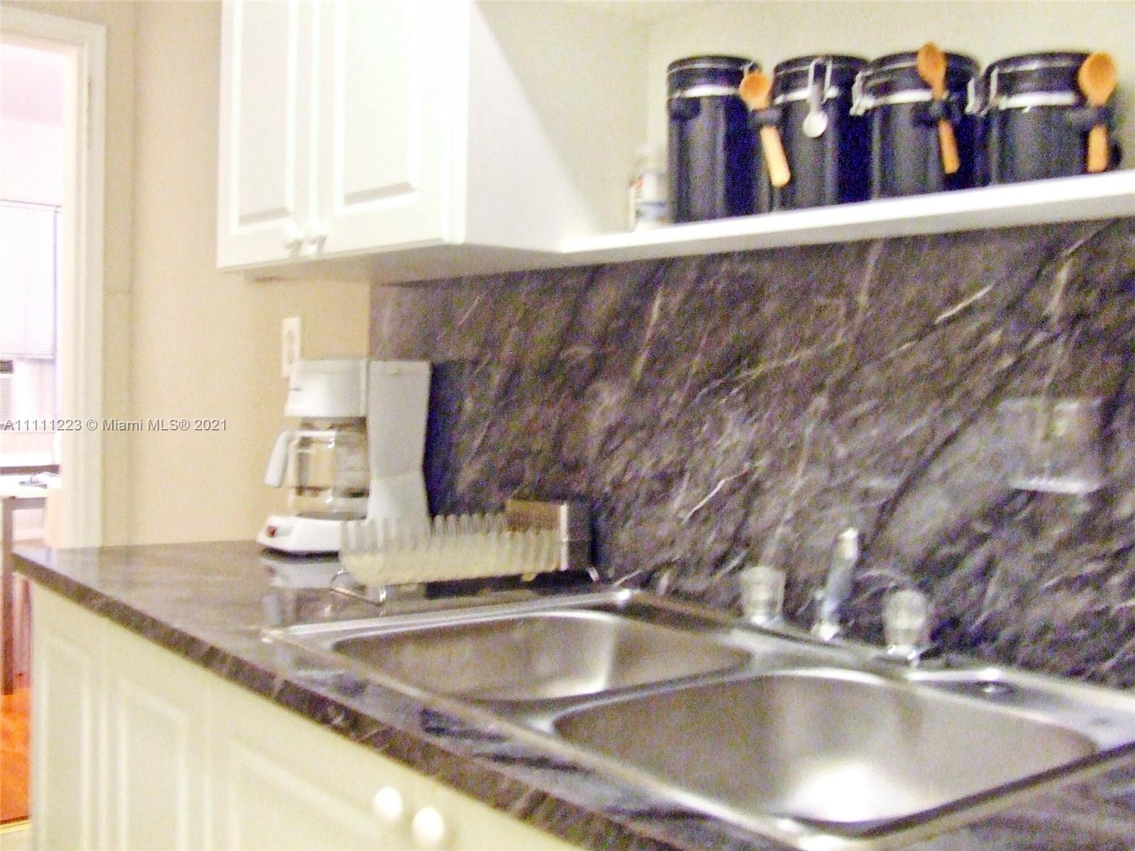 635 83rd Street, Unit 47 Miami Beach, FL 33141 - Photo 3 of 16 a close view of a sink and a window