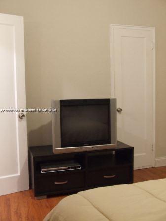 635 83rd Street, Unit 47 Miami Beach, FL 33141 - Photo 8 of 16 a living room with a flat screen tv and a potted plant
