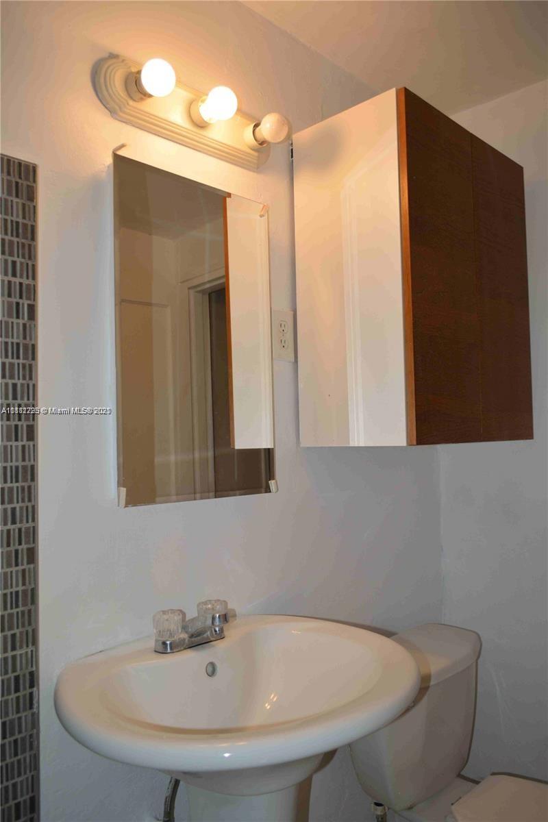 635 83rd Street, Unit 47 Miami Beach, FL 33141 - Photo 10 of 16 a bathroom with a sink and a mirror