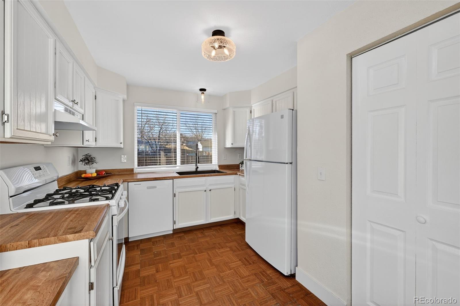 7586 Chase Street Arvada, CO 80003 - Photo 11 of 35 a kitchen with stainless steel appliances a refrigerator sink and cabinets