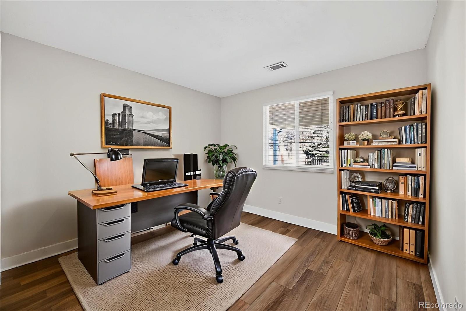 7586 Chase Street Arvada, CO 80003 - Photo 18 of 35 a view of a workspace with furniture and a bookshelf