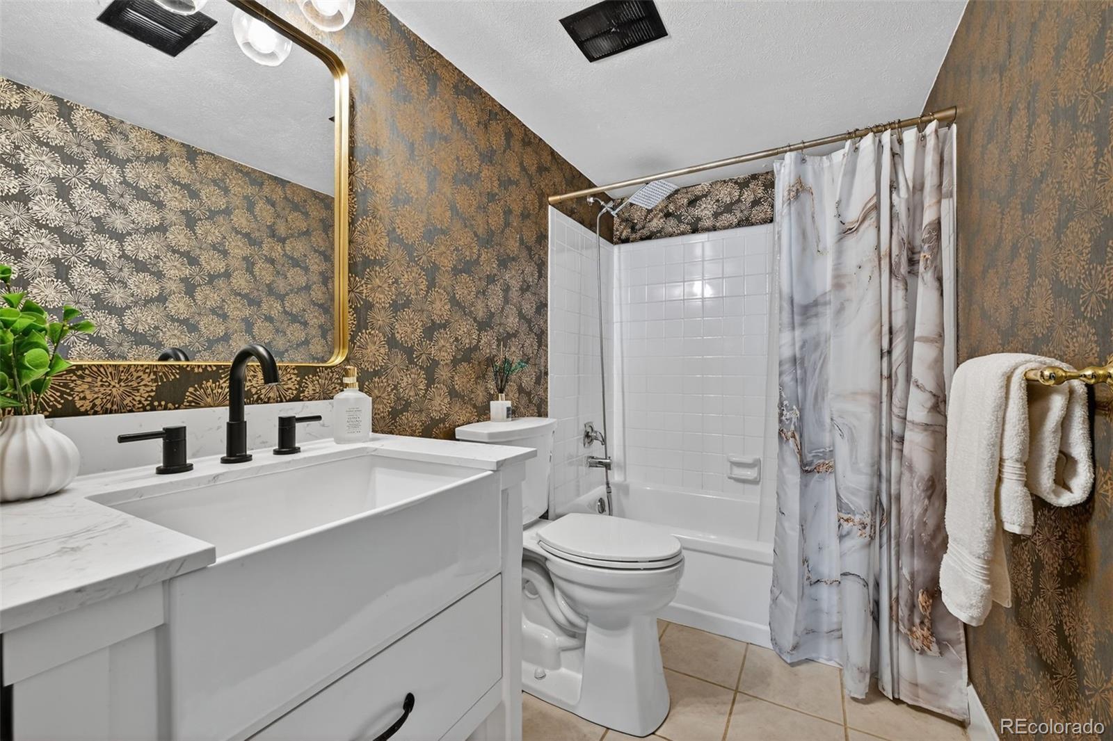 7586 Chase Street Arvada, CO 80003 - Photo 20 of 35 a bathroom with a sink a toilet and shower