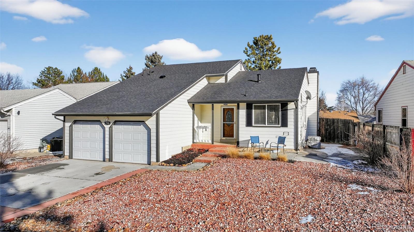7586 Chase Street Arvada, CO 80003 - Photo 2 of 35 a front view of a house with a porch