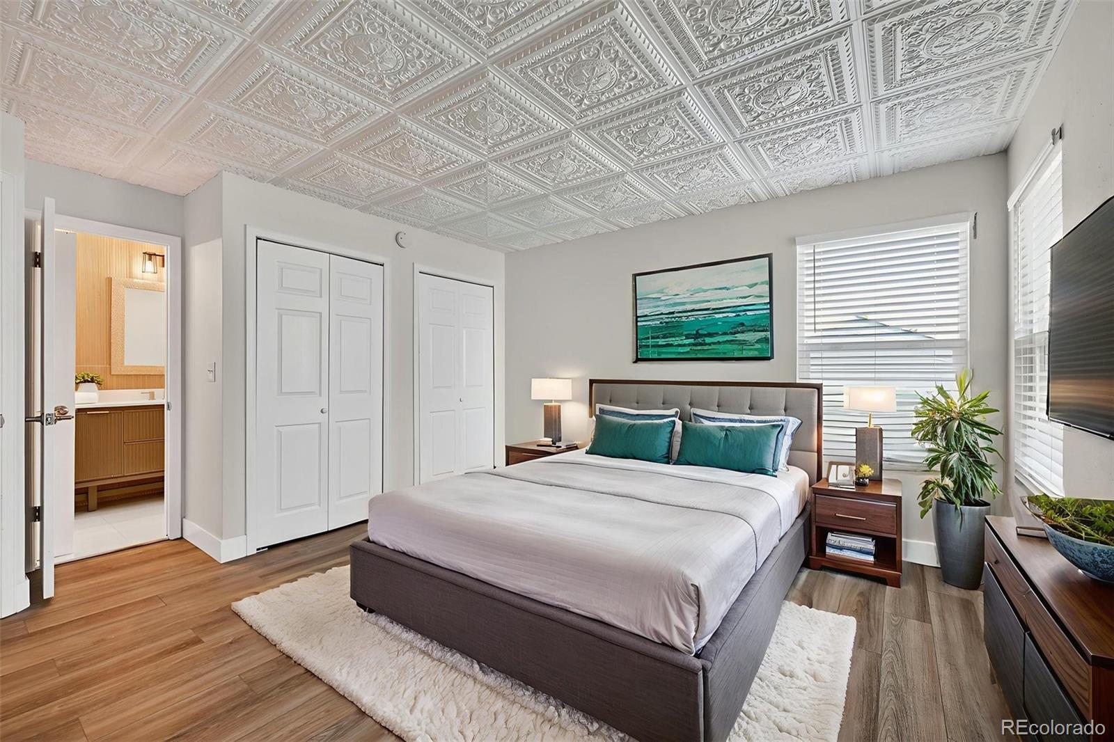 7586 Chase Street Arvada, CO 80003 - Photo 23 of 35 a bedroom with a bed and wooden floor