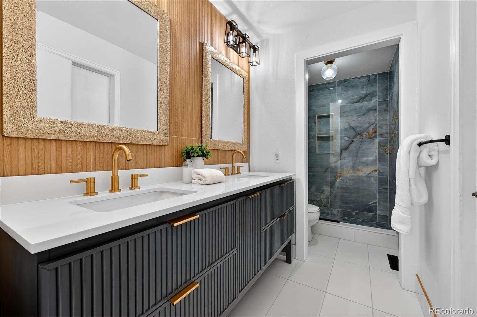 7586 Chase Street Arvada, CO 80003 - Photo 24 of 35 a bathroom with a sink and a mirror