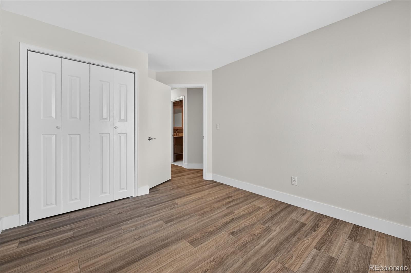 7586 Chase Street Arvada, CO 80003 - Photo 26 of 35 a view of an empty room with wooden floor