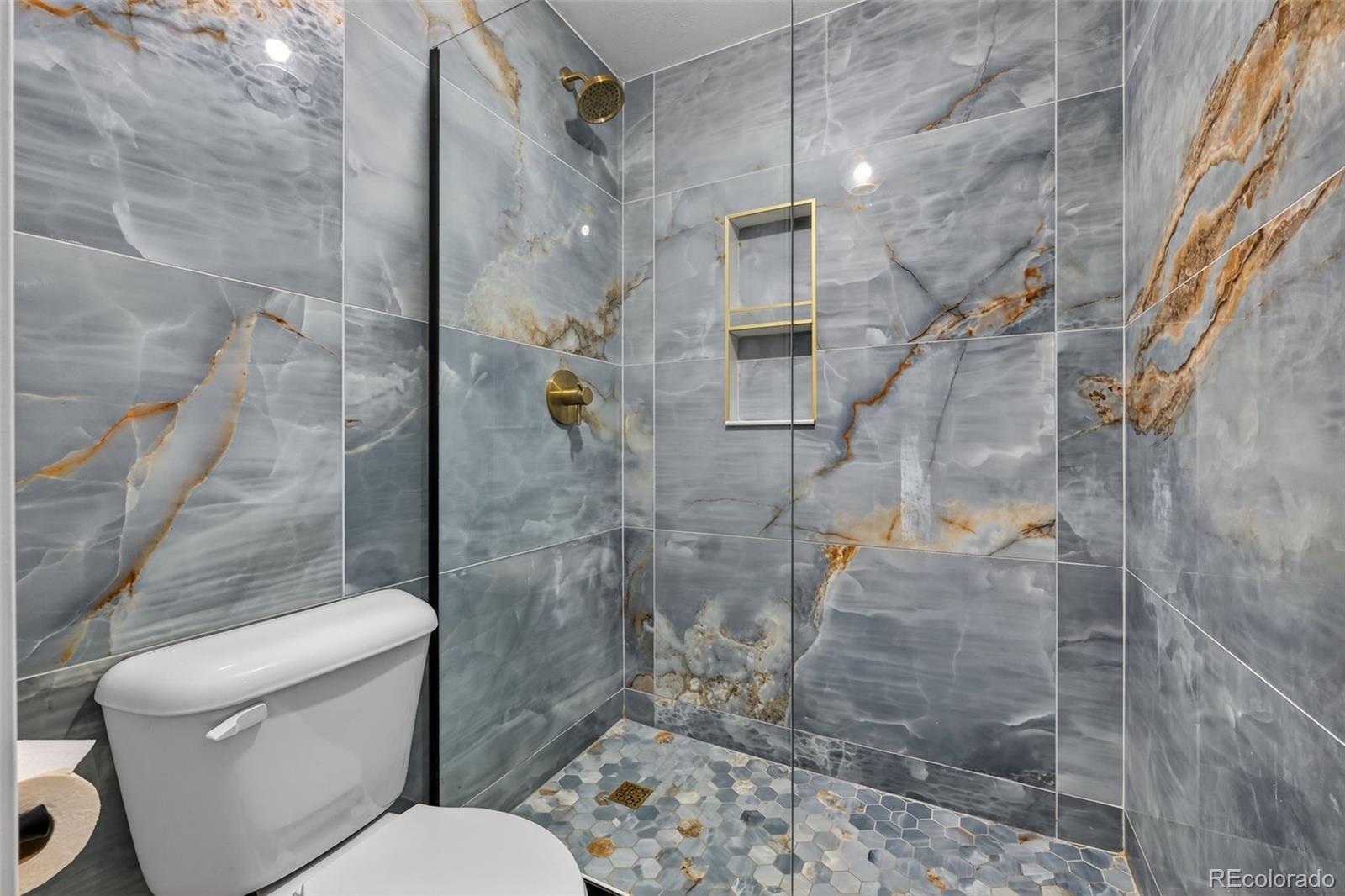 7586 Chase Street Arvada, CO 80003 - Photo 27 of 35 a bathroom with a toilet and shower