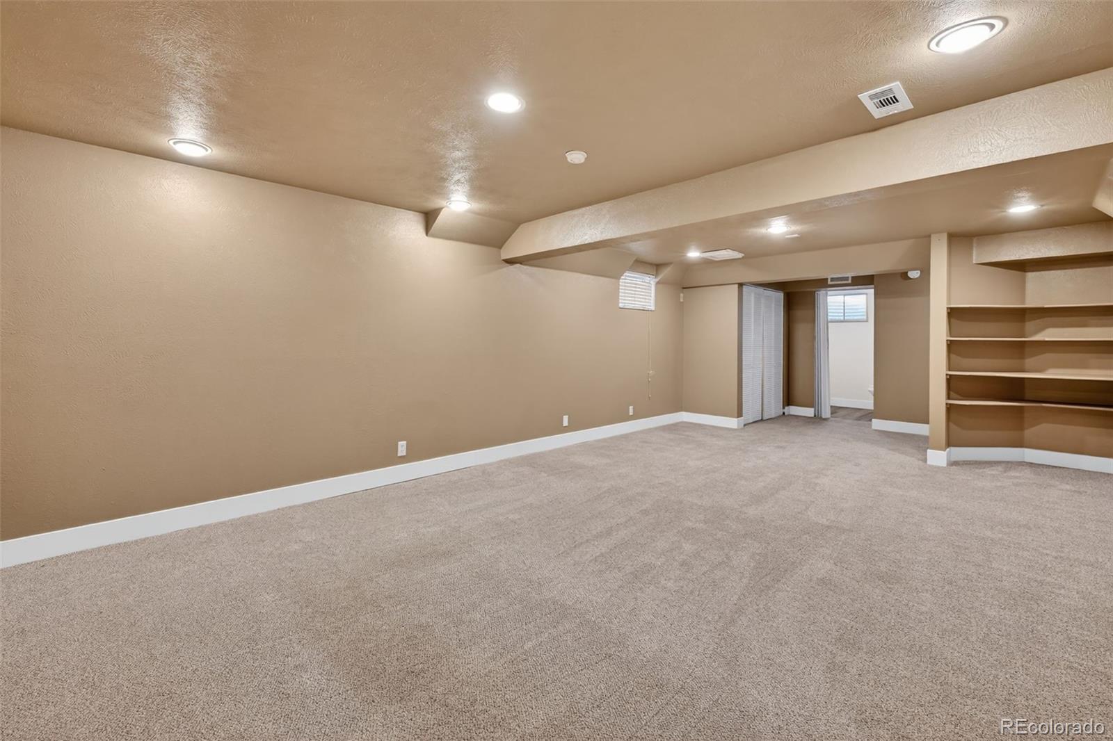 7586 Chase Street Arvada, CO 80003 - Photo 30 of 35 an empty room with closet and windows