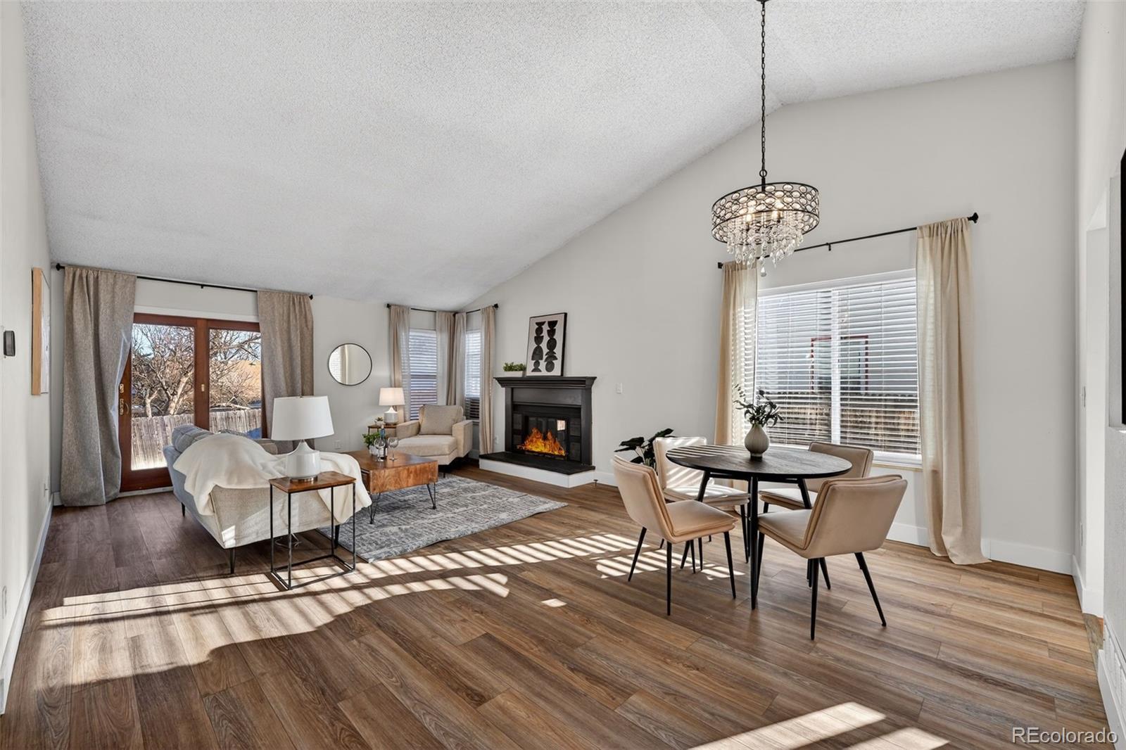 7586 Chase Street Arvada, CO 80003 - Photo 6 of 35 a living room with furniture and a chandelier