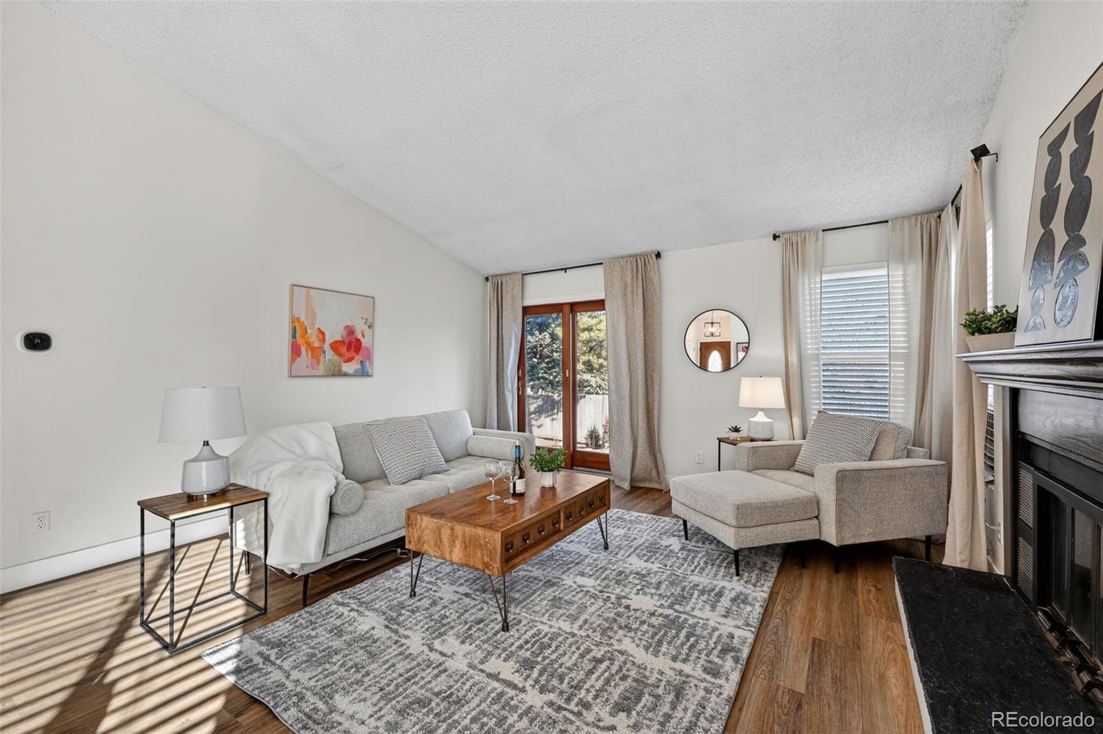 7586 Chase Street Arvada, CO 80003 - Photo 7 of 35 a living room with furniture and a rug