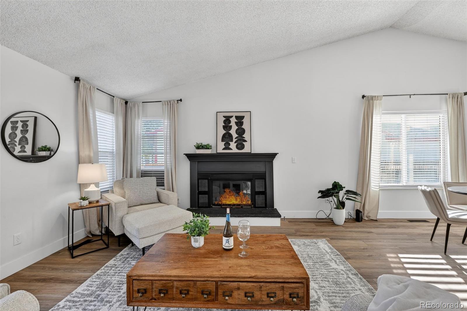 7586 Chase Street Arvada, CO 80003 - Photo 8 of 35 a living room with furniture a fireplace and a large window