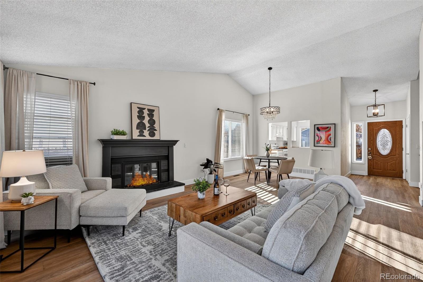 7586 Chase Street Arvada, CO 80003 - Photo 9 of 35 a living room with furniture and a fireplace