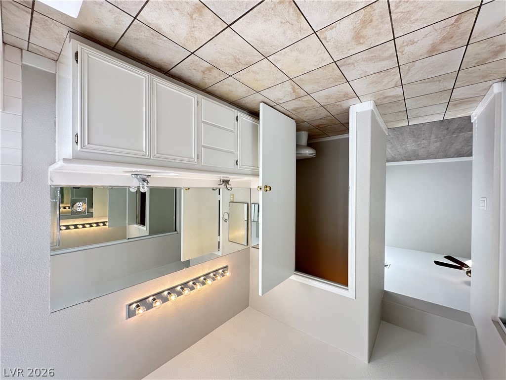 10191 Splendor Ridge Avenue Las Vegas, NV 89135 - Photo 23 of 31 Functional vanity storage and bright lighting create an efficient and well-appointed bathroom space.