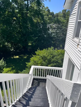 a view of a wooden deck and a backyard